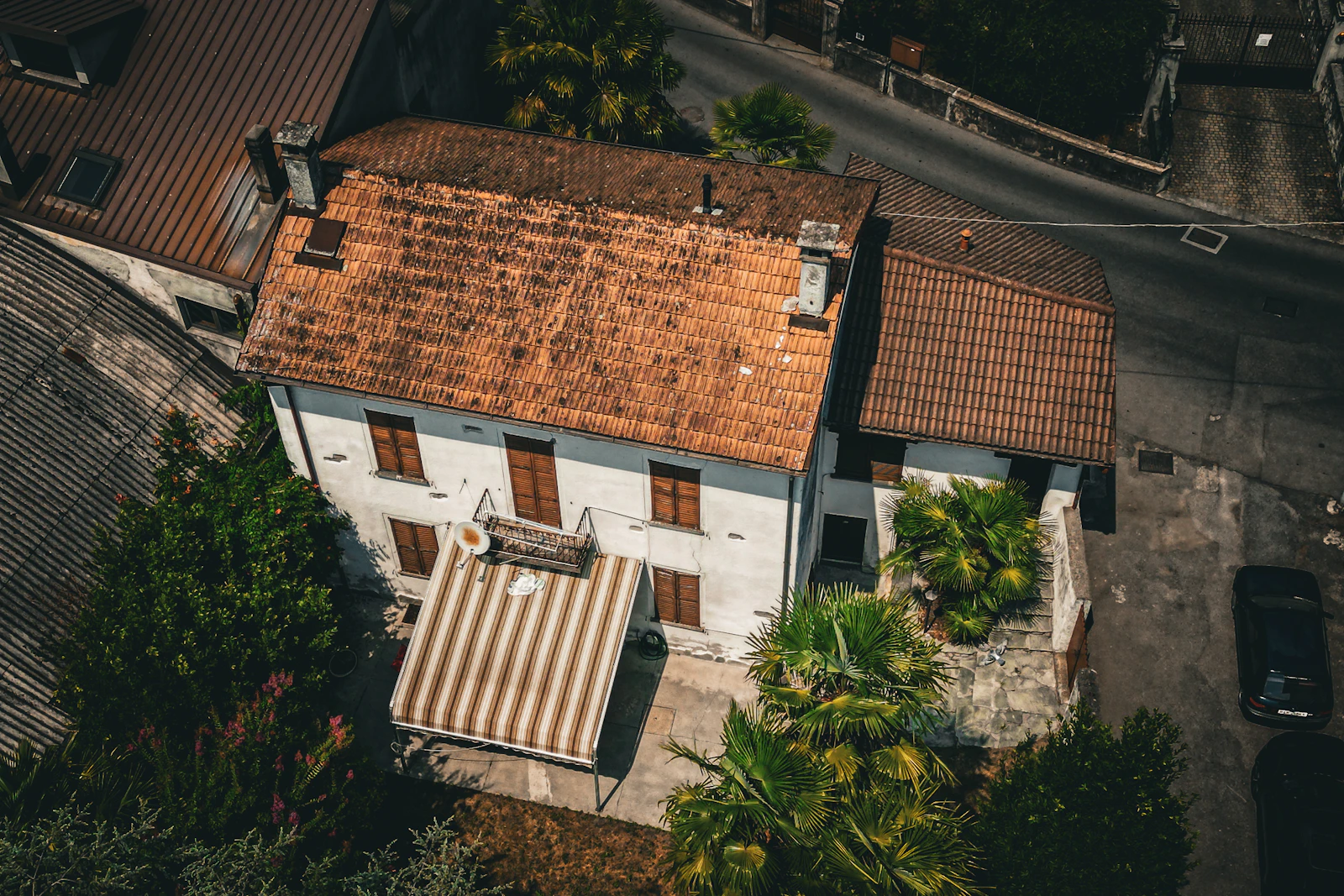 Aerial view of a house with an established tiled roof